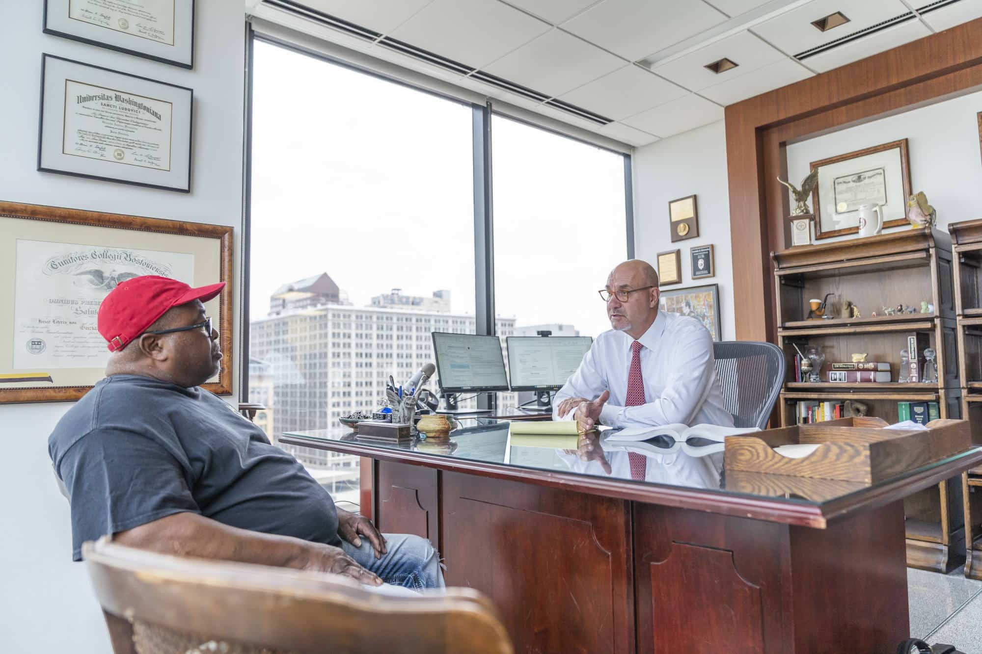 Attorney Gonzalo sitting with a client discussing his case